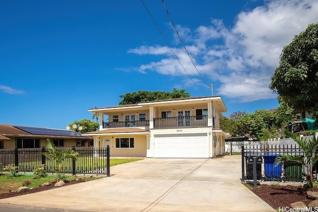 84-160 Jade St, Waianae, HI 96792 - view of front of home with concrete driveway, an attached garage, a balcony, and a fenced front yard