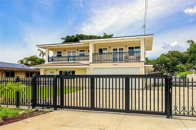 84-160 Jade St, Waianae, HI 96792 - view of front of home with a balcony, an attached garage, a fenced front yard, concrete driveway, and a gate
