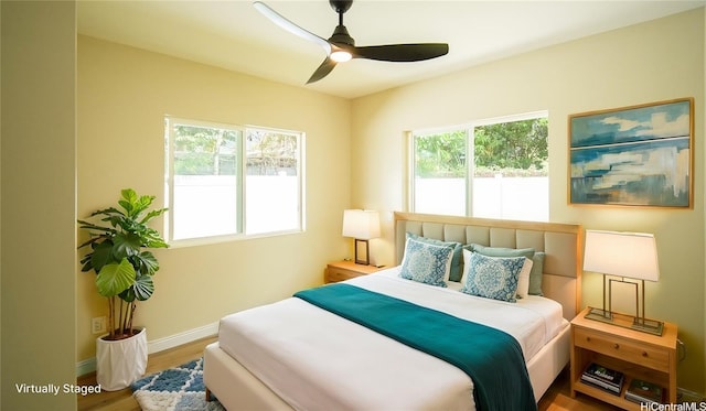84-160 Jade St, Waianae, HI 96792 - bedroom featuring baseboards, wood finished floors, and a ceiling fan