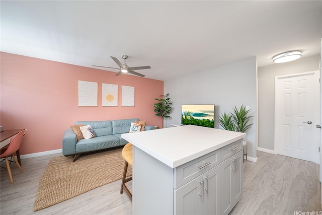 1401 Lusitana St Unit 504, Honolulu, HI 96813 - living room featuring a ceiling fan, light wood-style flooring, and baseboards