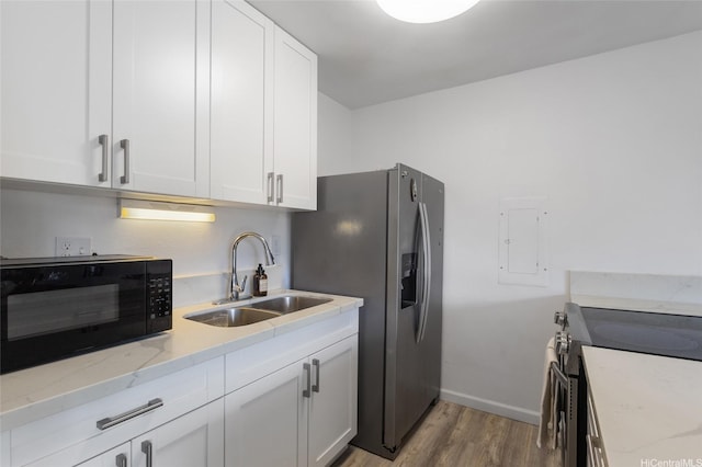 84-707 Kiana Pl Unit 107B, Waianae, HI 96792 - kitchen with appliances with stainless steel finishes, a sink, light wood-style flooring, light stone countertops, and white cabinetry