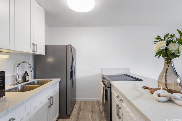 84-707 Kiana Pl Unit 107B, Waianae, HI 96792 - kitchen with stainless steel electric range oven, a sink, light wood-style flooring, and white cabinetry