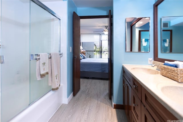 500 Lunalilo Home Rd Unit 22B, Honolulu, HI 96825 - full bathroom featuring wood finished floors, ensuite bathroom, double vanity, a ceiling fan, and shower / bath combination with glass door