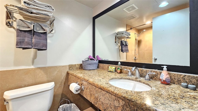 1850 Ala Moana Blvd Unit 222, Honolulu, HI 96815 - full bath with toilet, a tile shower, vanity, tile walls, and wainscoting