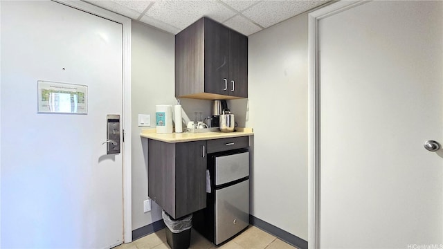 1850 Ala Moana Blvd Unit 222, Honolulu, HI 96815 - bar with a paneled ceiling, light tile patterned flooring, and baseboards