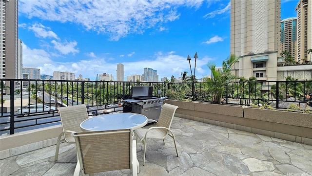 1850 Ala Moana Blvd Unit 222, Honolulu, HI 96815 - view of patio with a skyline view, a balcony, and outdoor dining space