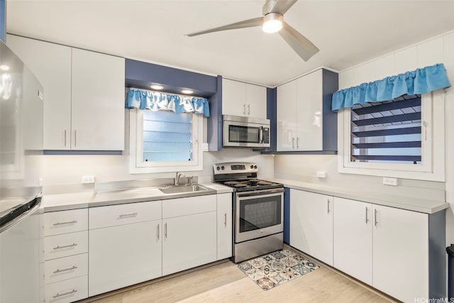 1614 Hoolulu Rd, Wahiawa, HI 96786 - kitchen featuring stainless steel appliances, light countertops, white cabinets, light wood-style flooring, and a ceiling fan