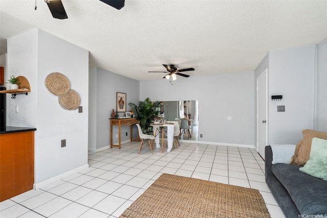 68-077 Au St Unit 2D, Waialua, HI 96791 - living room with ceiling fan, light tile patterned floors, a textured ceiling, and baseboards