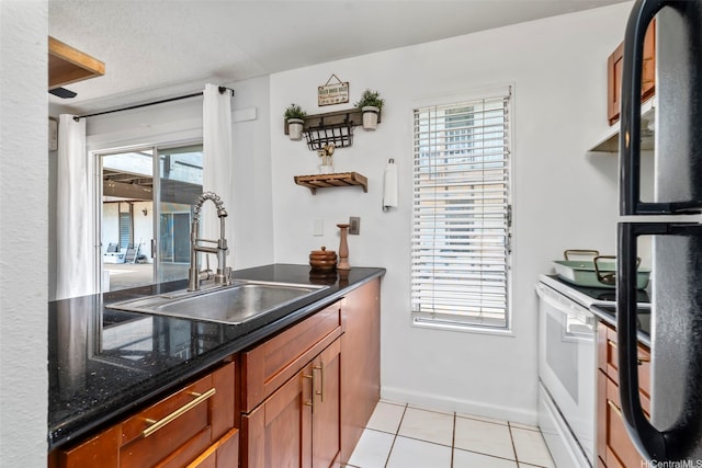 68-077 Au St Unit 2D, Waialua, HI 96791 - kitchen featuring a sink, electric range, freestanding refrigerator, light tile patterned flooring, and plenty of natural light