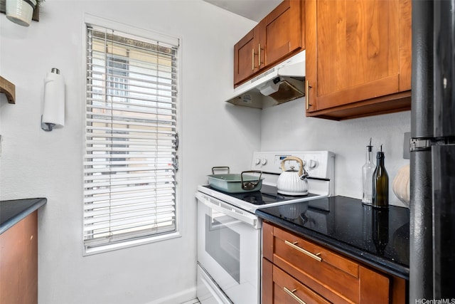 68-077 Au St Unit 2D, Waialua, HI 96791 - kitchen featuring white electric range oven, under cabinet range hood, freestanding refrigerator, and plenty of natural light