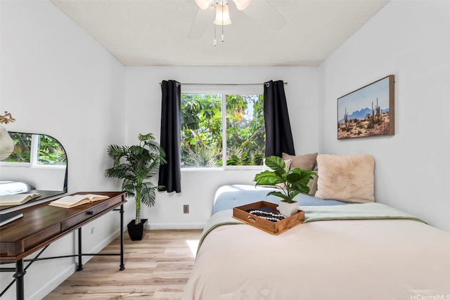 68-077 Au St Unit 2D, Waialua, HI 96791 - bedroom featuring wood finished floors, multiple windows, baseboards, and a desk