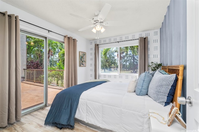 68-077 Au St Unit 2D, Waialua, HI 96791 - bedroom with access to exterior, multiple windows, light wood-type flooring, and ceiling fan