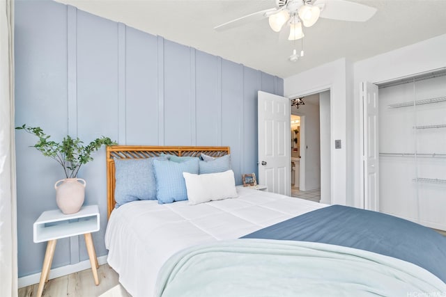 68-077 Au St Unit 2D, Waialua, HI 96791 - bedroom featuring a closet, ceiling fan, a decorative wall, and light wood-style floors