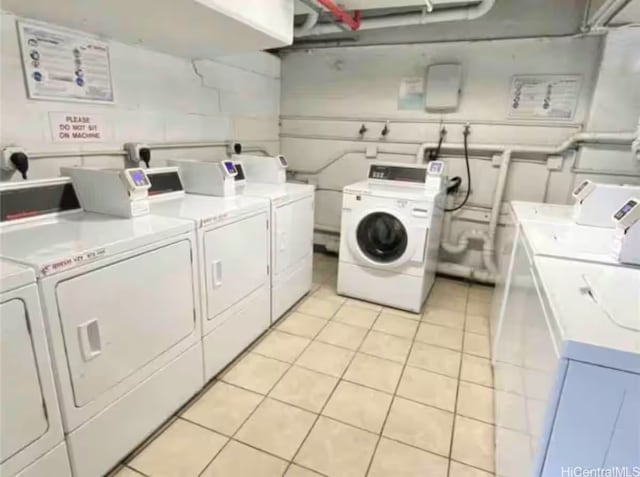 1850 Ala Moana Blvd Unit 223, Honolulu, HI 96815 - communal laundry room with washer and clothes dryer and light tile patterned floors