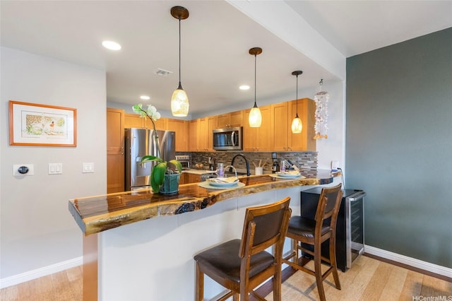 7012 Hawaii Kai Dr Unit 904, Honolulu, HI 96825 - kitchen featuring stainless steel appliances, a peninsula, baseboards, backsplash, and recessed lighting