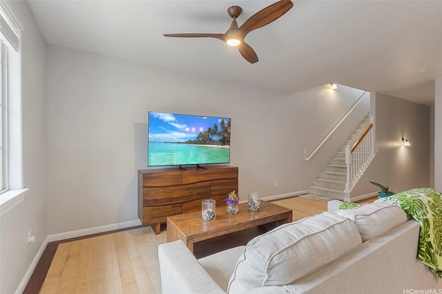 7012 Hawaii Kai Dr Unit 904, Honolulu, HI 96825 - living area with a ceiling fan, baseboards, light wood-type flooring, and stairs