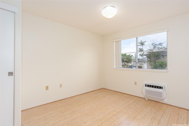 95-1025 Kaapeha St Unit 203, Mililani, HI 96789 - spare room featuring a wall mounted AC and wood finished floors