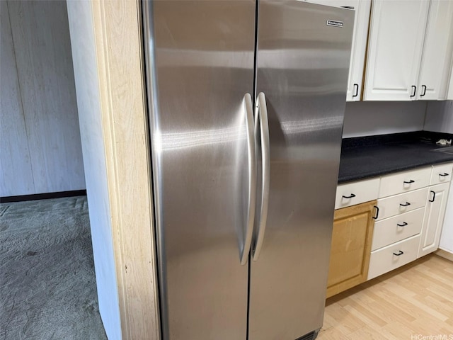 1717 Ala Wai Blvd Unit 306, Honolulu, HI 96815 - kitchen featuring freestanding refrigerator, dark countertops, white cabinetry, and light wood finished floors