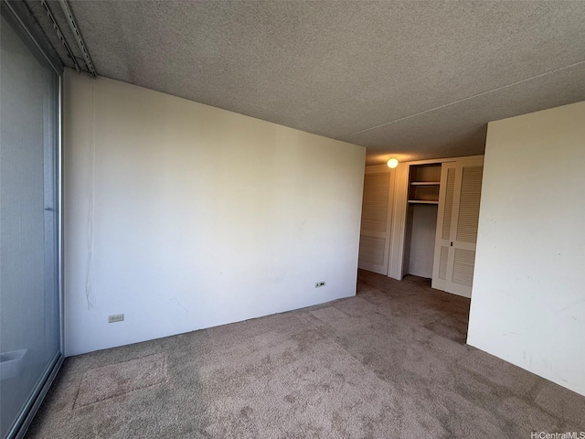 1717 Ala Wai Blvd Unit 306, Honolulu, HI 96815 - unfurnished bedroom featuring carpet, a closet, and a textured ceiling
