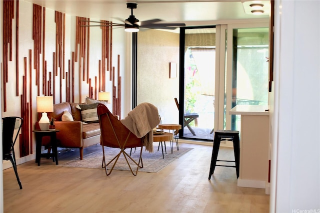 3823 Lower Honoapiilani Rd Unit 105, Lahaina, HI 96761 - sitting room with healthy amount of natural light, ceiling fan, light wood-style flooring, and baseboards