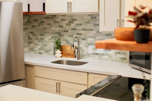 3823 Lower Honoapiilani Rd Unit 105, Lahaina, HI 96761 - kitchen with appliances with stainless steel finishes, a sink, light countertops, decorative backsplash, and white cabinets