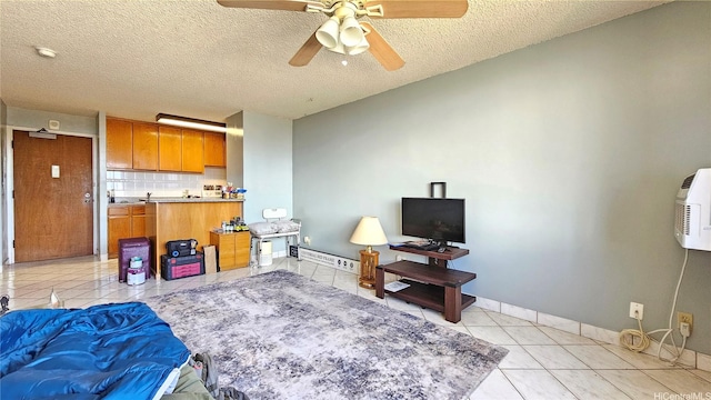 2040 Nuuanu Ave Unit 404, Honolulu, HI 96817 - living room featuring light tile patterned floors, ceiling fan, baseboards, and a textured ceiling