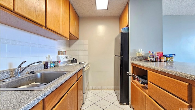 2040 Nuuanu Ave Unit 404, Honolulu, HI 96817 - kitchen featuring white electric range, freestanding refrigerator, a sink, brown cabinetry, and a textured ceiling