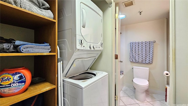 2040 Nuuanu Ave Unit 404, Honolulu, HI 96817 - laundry room featuring stacked washing machine and dryer and light tile patterned flooring