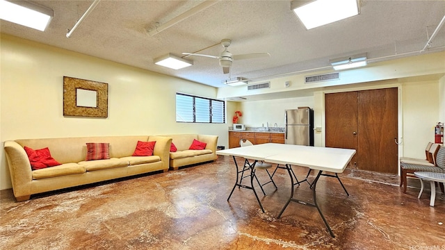 2040 Nuuanu Ave Unit 404, Honolulu, HI 96817 - living room with finished concrete floors, a ceiling fan, and a textured ceiling