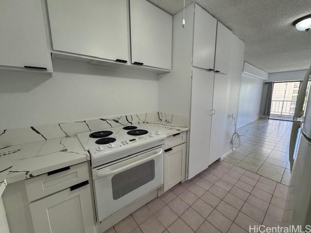 303 Liliuokalani Ave Unit 602, Honolulu, HI 96815 - kitchen featuring a textured ceiling, electric range, white cabinets, light tile patterned flooring, and light stone counters
