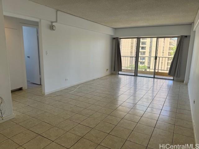 303 Liliuokalani Ave Unit 602, Honolulu, HI 96815 - spare room featuring a textured ceiling and tile patterned floors