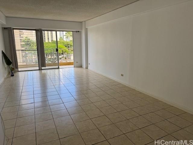 303 Liliuokalani Ave Unit 602, Honolulu, HI 96815 - spare room featuring tile patterned floors and a textured ceiling