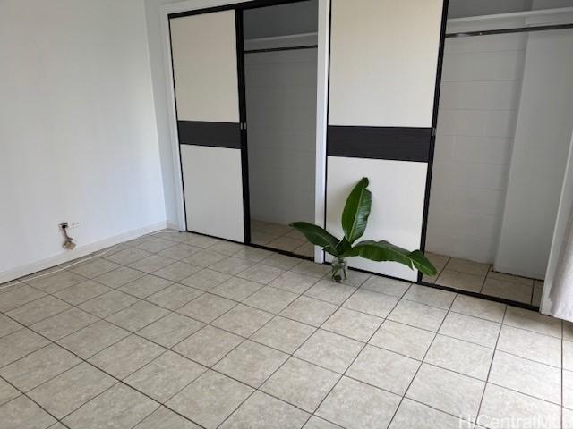 303 Liliuokalani Ave Unit 602, Honolulu, HI 96815 - unfurnished bedroom featuring light tile patterned floors