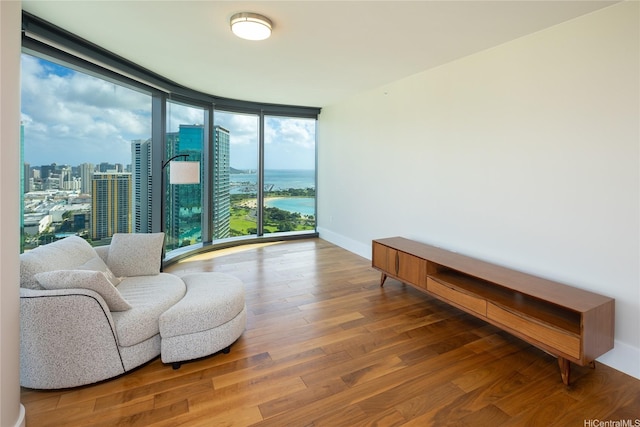 1108 Auahi St Unit 3108, Honolulu, HI 96814 - living area featuring a wall of windows, wood finished floors, baseboards, a water view, and a city view