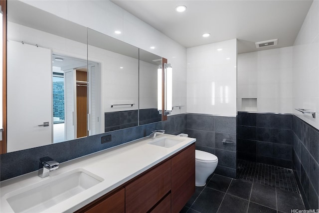 1108 Auahi St Unit 3108, Honolulu, HI 96814 - bathroom with tile walls, toilet, double vanity, tile patterned flooring, and a wainscoted wall