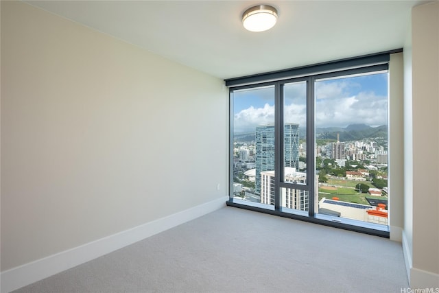 1108 Auahi St Unit 3108, Honolulu, HI 96814 - spare room with floor to ceiling windows, healthy amount of natural light, a view of city, carpet flooring, and baseboards
