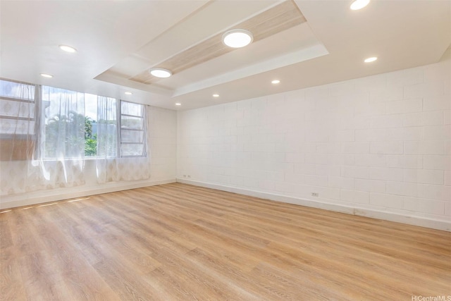 98-1040 Moanalua Rd Unit 1-201, Aiea, HI 96701 - empty room featuring a tray ceiling, light wood-style floors, recessed lighting, and concrete block wall
