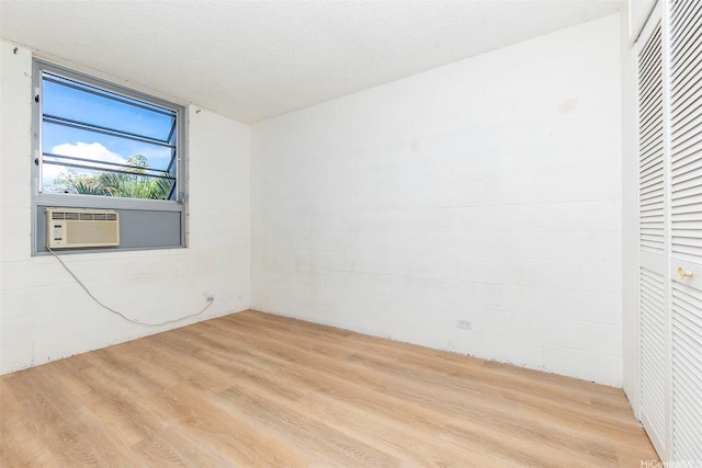 98-1040 Moanalua Rd Unit 1-201, Aiea, HI 96701 - empty room with wood finished floors, cooling unit, and concrete block wall