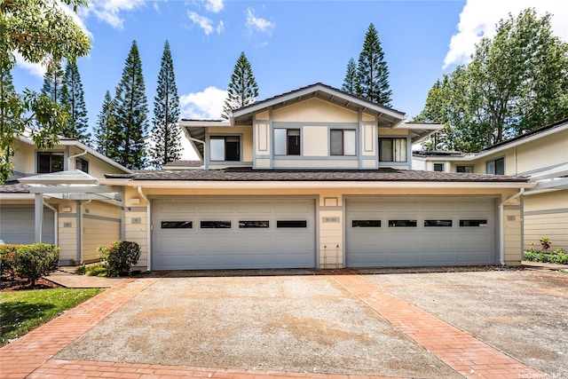 95-280 Ualalehu St Unit 18, Mililani, HI 96789 - view of front facade featuring concrete driveway, an attached garage, and stucco siding