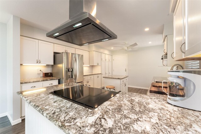 95-280 Ualalehu St Unit 18, Mililani, HI 96789 - kitchen featuring wall chimney range hood, stainless steel fridge, a center island, black electric cooktop, and baseboards