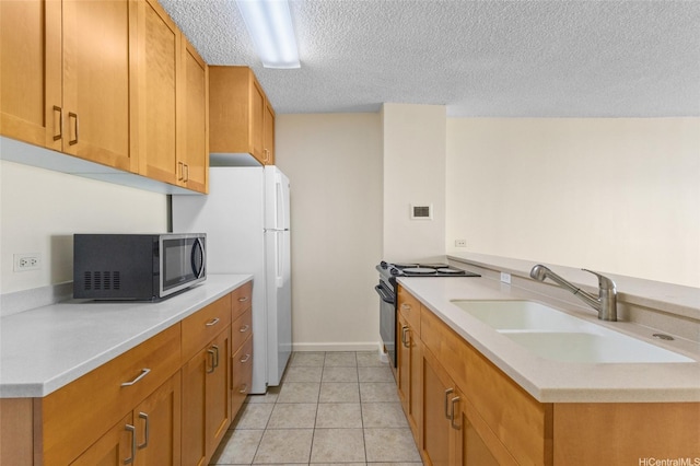 1050 Kinau St Unit 301, Honolulu, HI 96814 - kitchen with stainless steel microwave, a sink, black range oven, light countertops, and a textured ceiling