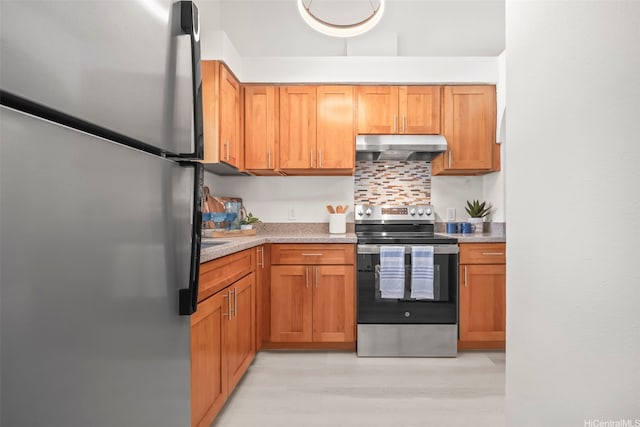 355 Aoloa St Unit D203, Kailua, HI 96734 - kitchen with appliances with stainless steel finishes, under cabinet range hood, light countertops, backsplash, and brown cabinetry