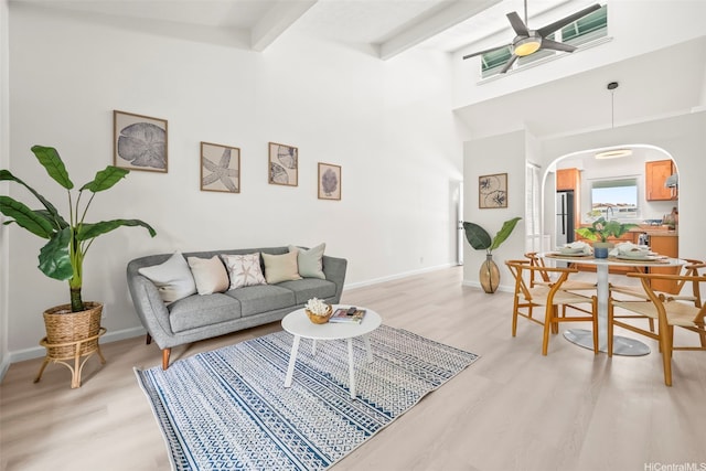 355 Aoloa St Unit D203, Kailua, HI 96734 - living area featuring arched walkways, light wood-style flooring, ceiling fan, baseboards, and beamed ceiling