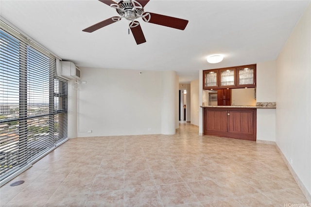 2101 Nuuanu Ave Unit I-1002, Honolulu, HI 96817 - unfurnished living room featuring healthy amount of natural light, a ceiling fan, and light tile patterned flooring