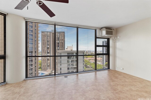 2101 Nuuanu Ave Unit I-1002, Honolulu, HI 96817 - tiled empty room with a wall of windows, a ceiling fan, and a wall mounted air conditioner
