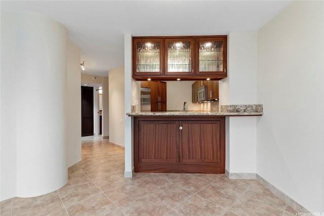 2101 Nuuanu Ave Unit I-1002, Honolulu, HI 96817 - indoor wet bar featuring built in appliances, light tile patterned flooring, and baseboards