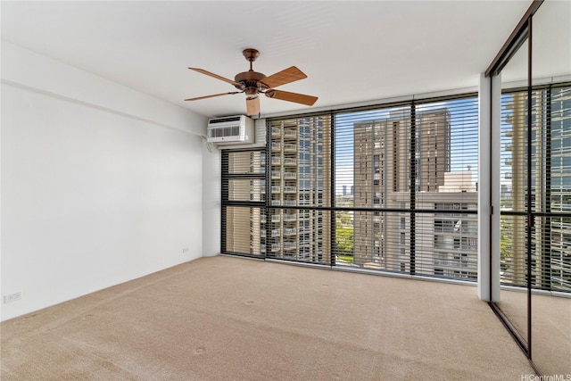 2101 Nuuanu Ave Unit I-1002, Honolulu, HI 96817 - carpeted empty room featuring a wall mounted air conditioner, a ceiling fan, floor to ceiling windows, and a city view