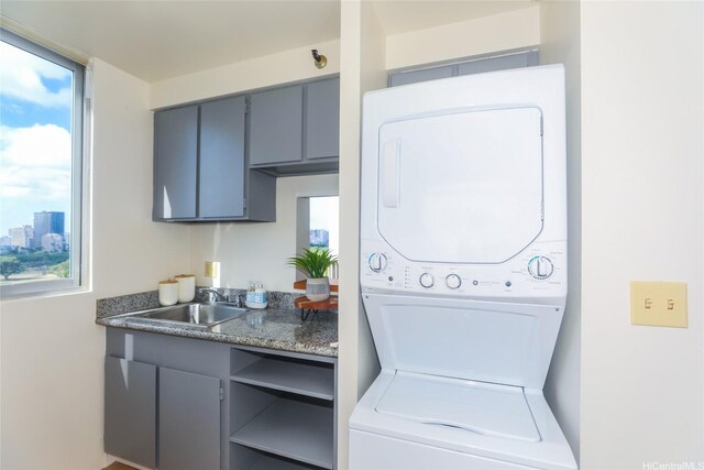 2916 Date St Unit 10I, Honolulu, HI 96816 - laundry room featuring stacked washer and clothes dryer and plenty of natural light