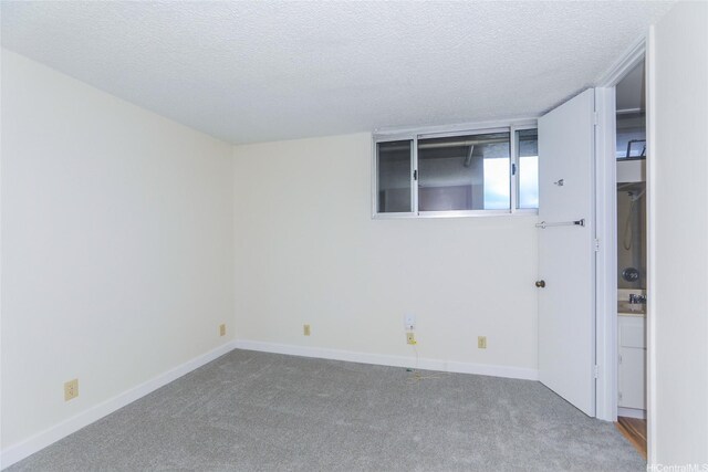 2916 Date St Unit 10I, Honolulu, HI 96816 - carpeted empty room with a textured ceiling and baseboards