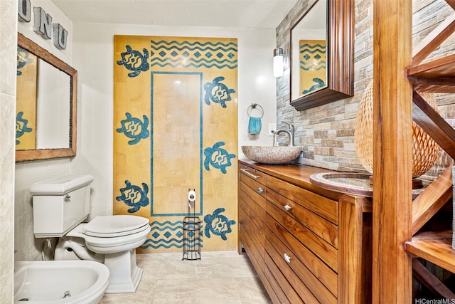87-561 Farrington Hwy Unit 102, Waianae, HI 96792 - bathroom with a bidet, toilet, double vanity, and backsplash